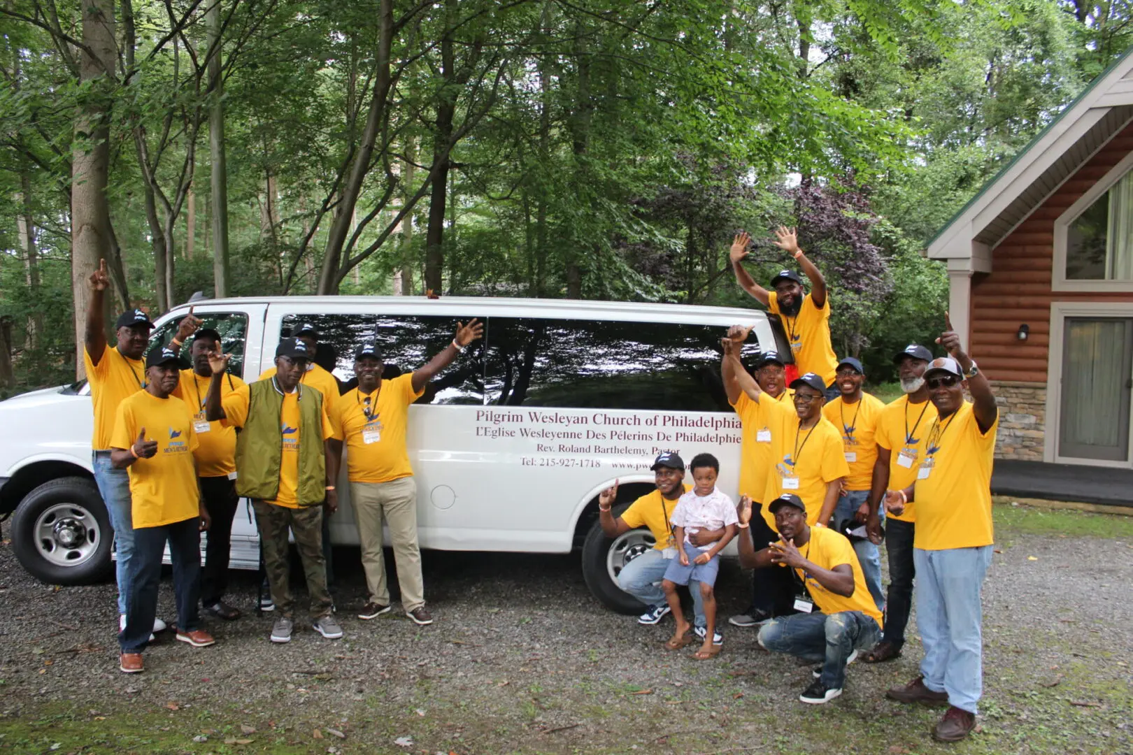 Group celebrating in front of white van