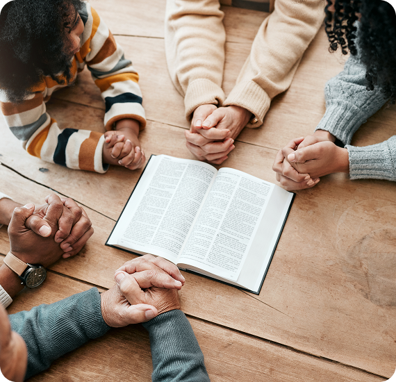 Group prayer with open book